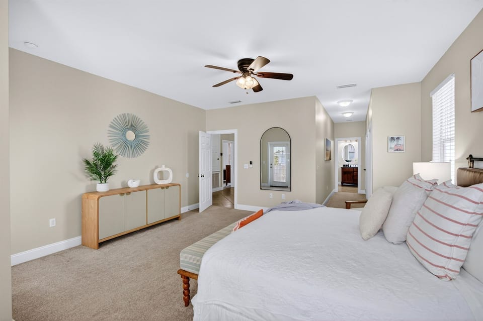 Main House 2nd Floor - King bedroom with private balcony and ensuite bathroom featuring a walk-in shower and double sinks.