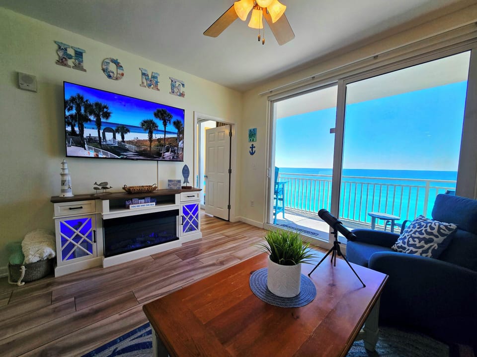 Direct beachfront living room with a huge TV and Cozy Electric Fireplace
