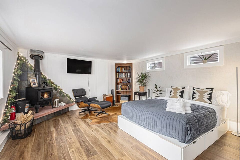 Queen bed for dreaming, lounge chair for getting lost in a book, smart TV for your favourite show.***Stylish fireplace included for looks only—please don’t use.***