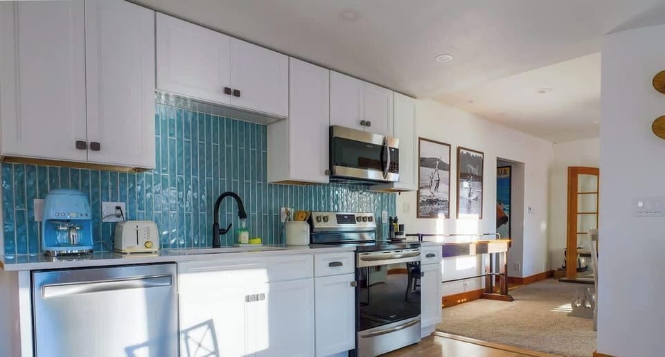 Fully equipped kitchen with stainless appliances and plenty of counter space for preparing meals.