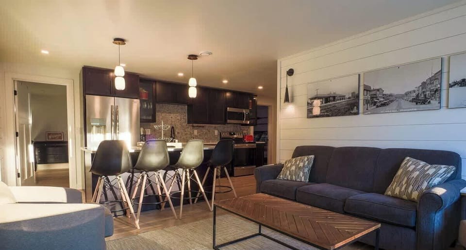 Inviting open-concept living room flowing seamlessly into the kitchen — ideal for gathering and relaxing after a day by the lake.