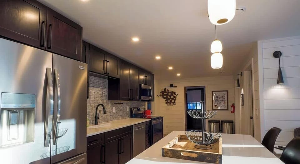 Modern, fully equipped kitchen featuring stainless steel appliances, ample counter space, and a large island centerpiece.