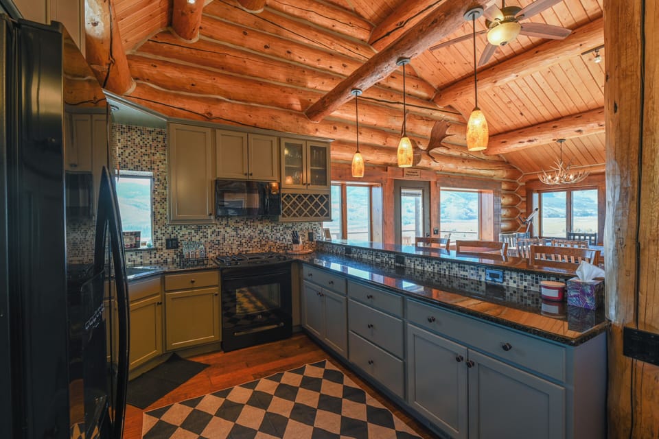 A bright, fully stocked kitchen with granite countertops, stainless appliances