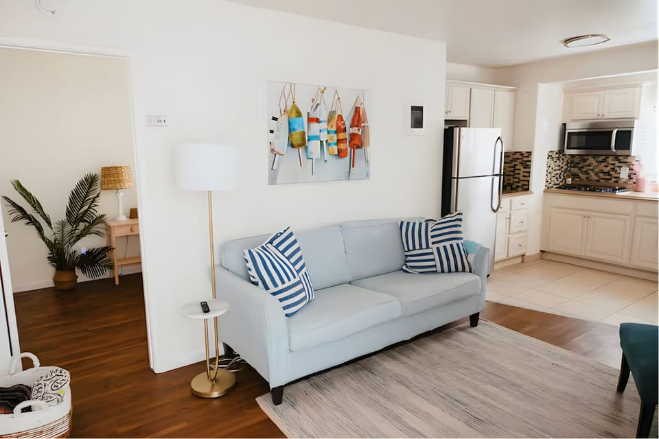 Light-filled living room with comfy seating and coastal touches.