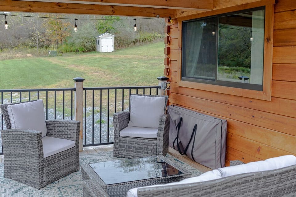 Covered porch seating perfect for morning coffee overlooking the yard