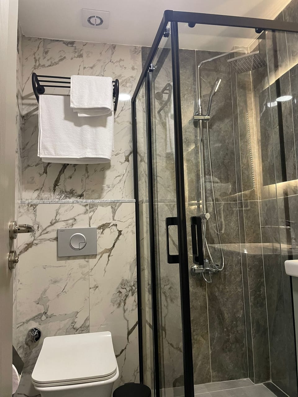Shower, hair dryer, slippers, towels