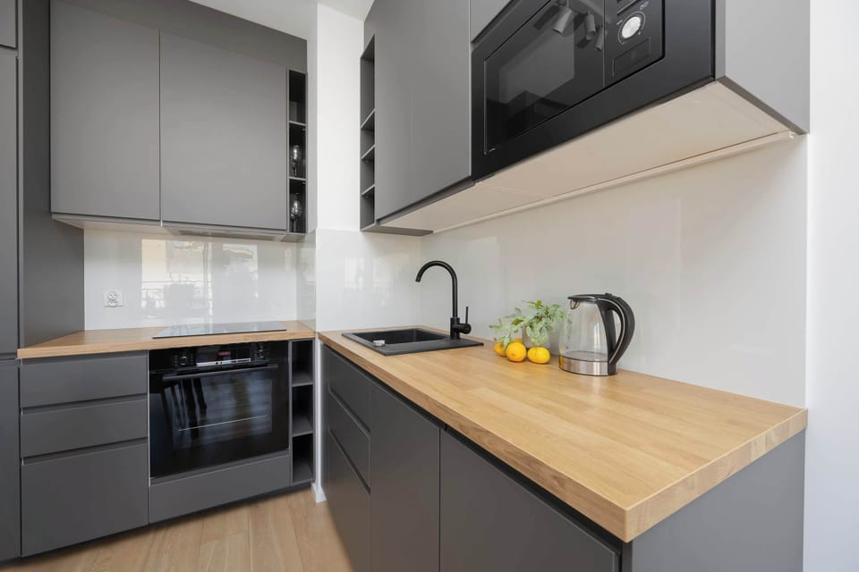 The stylish grey-toned kitchen is fully equipped for preparing your favorite meals.