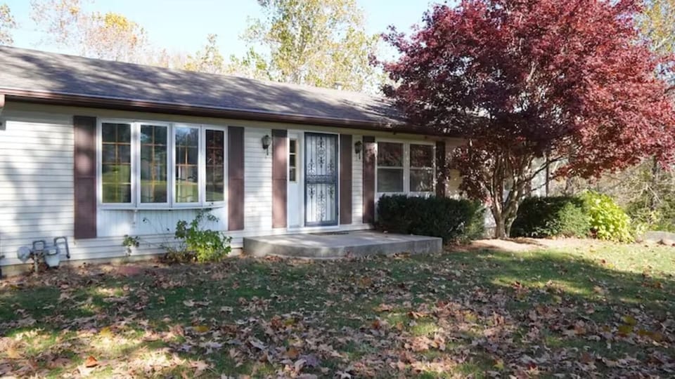 Arrive to peaceful curb appeal framed by colorful seasonal trees.