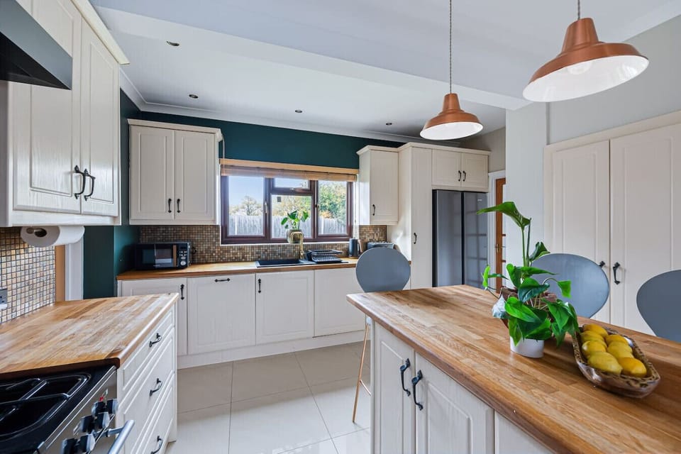The modern kitchen comes fully equipped with quality appliances and all the essentials for home cooking.