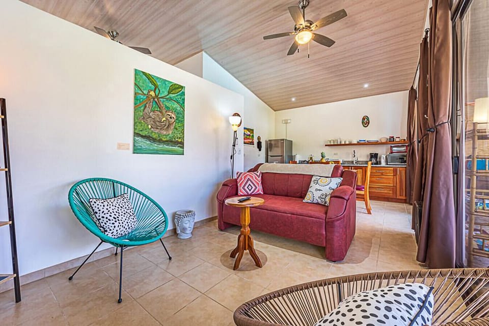 Airy living space with comfortable seating and tropical charm.