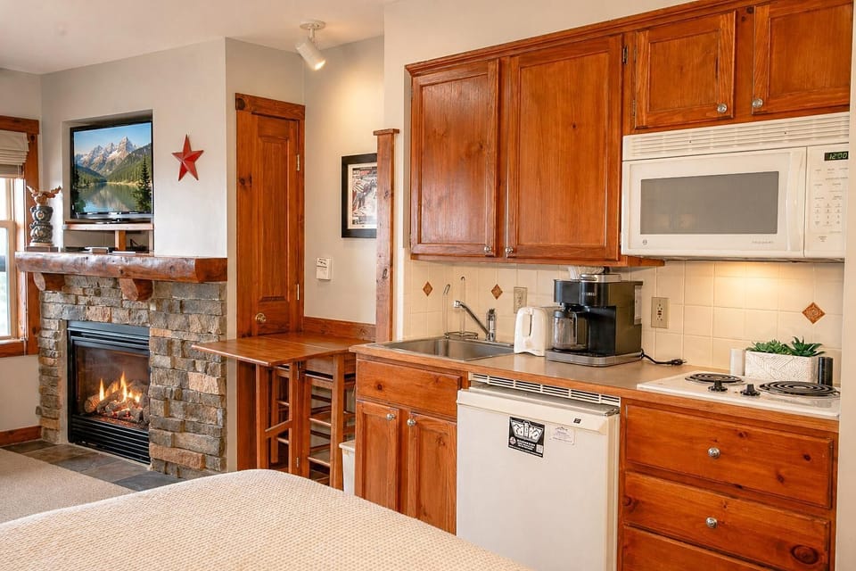 The kitchenette has an electric stovetop, microwave, and coffee maker perfect for quick snacks or meals.