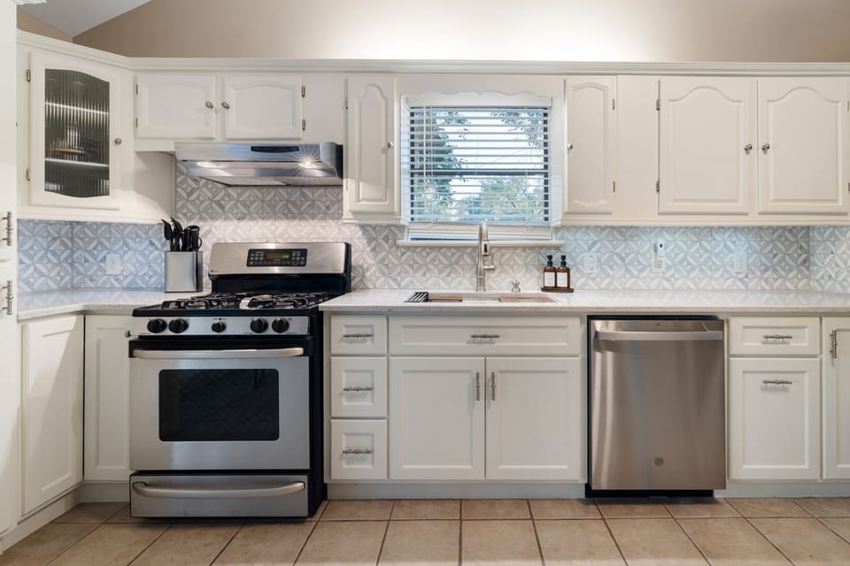 Gas stove with plenty of pots and pans. 