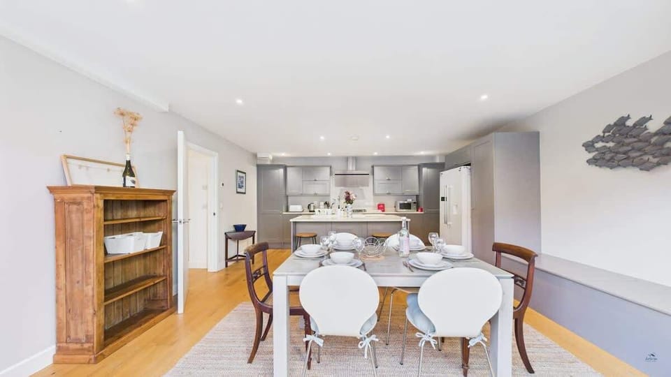 A second view of the kitchen area highlighting the ample workspace and modern lighting.