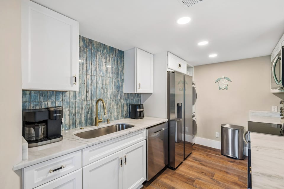 Fully stocked kitchen with stainless steel appliances and 4 barstools for extra seating.