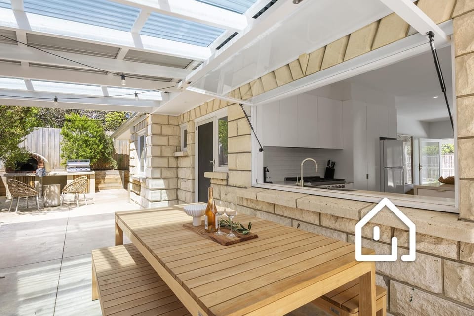 Outdoor dining for eight under a covered alfresco area