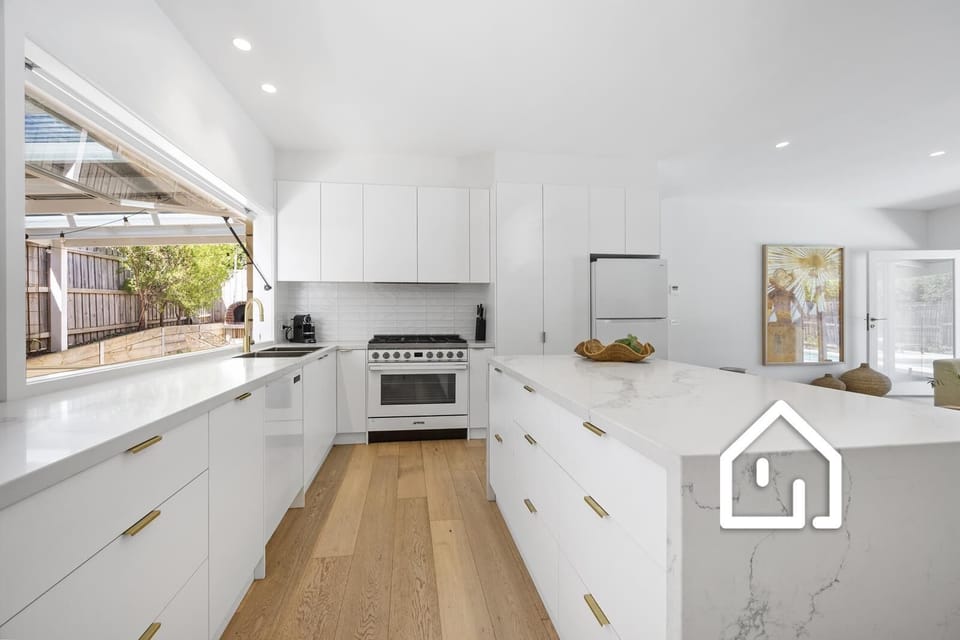Well-equipped kitchen with servery window to the alfresco