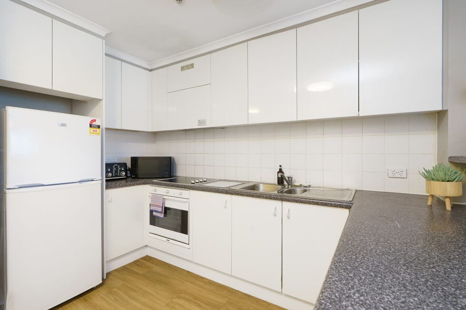 Modern kitchen featuring streamlined storage, quality appliances, and a fresh, minimalist look.