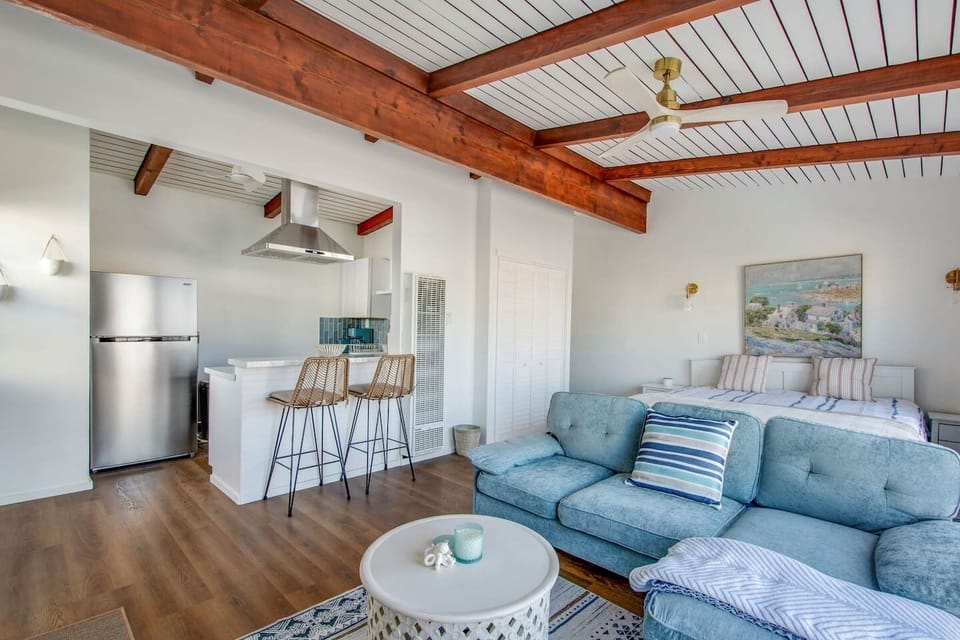 Enjoy a bright, open-concept layout featuring a king bed, comfy sofa, and breakfast bar seating.