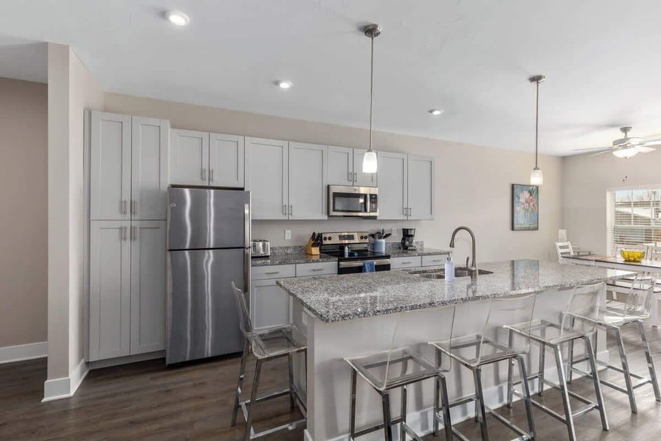 Modern open-concept kitchen featuring a bar — great for entertaining friends or family.