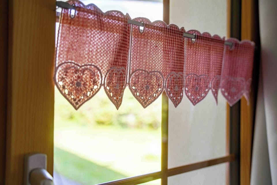 Traditional alpine curtains with garden view
