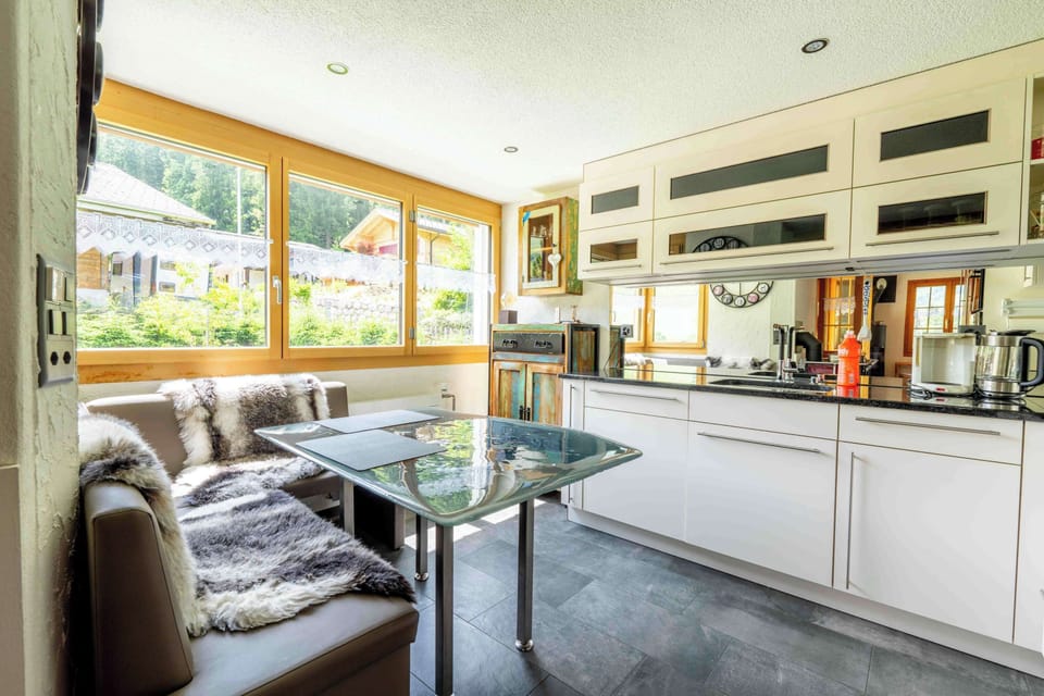 Bright kitchen and dining area with large windows
