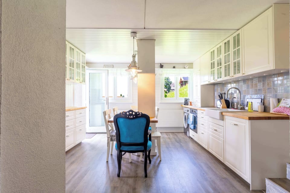 Kitchen and dining area with table and seating