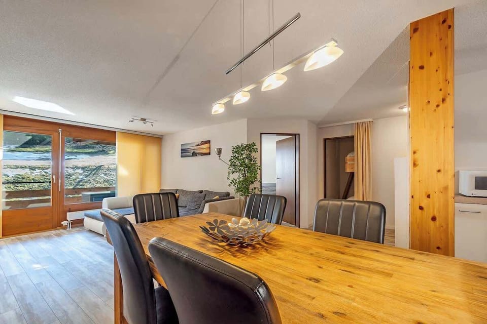 Spacious dining area with wooden table and modern interior