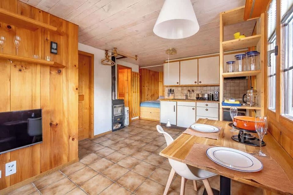 Open-plan kitchen and dining space with warm wooden finishes