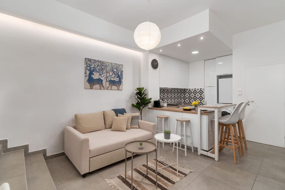 Bright and inviting lounge with comfortable seating, dining corner, and elegant lighting.