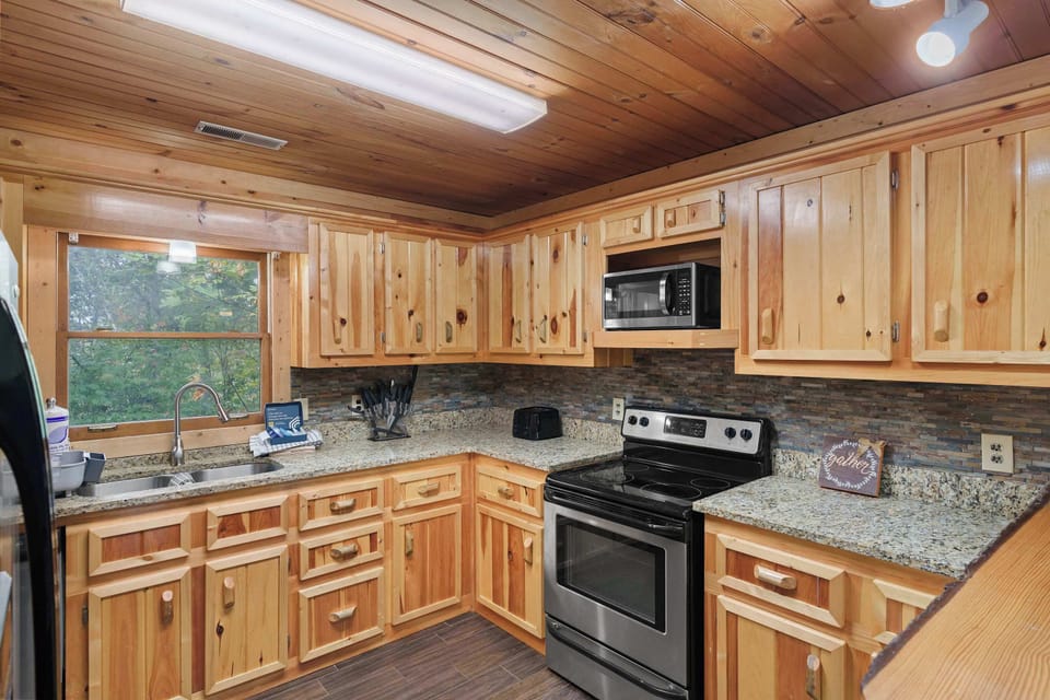 Whip up culinary delights in this charming wooden kitchen with nature views!