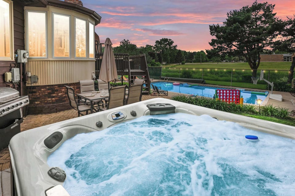 Our fenced in backyard  area has a hot tub, heated pool, lounge furniture, dining set, gas grill, pool furniture, and pool toys.