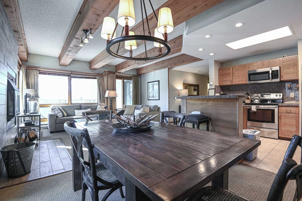 【Dining】Seats 4 under a chandelier — kitchen stays in the conversation
