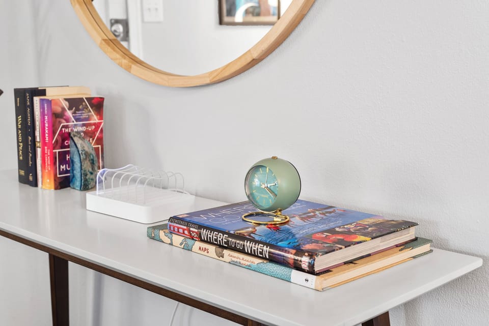 Thoughtfully styled details, like a classic clock and books, create a warm and welcoming atmosphere #CozyVibes #GuestComfort #AirbnbStyle