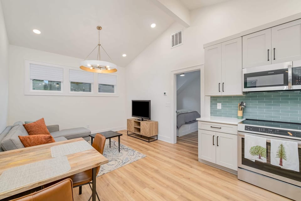 Bright living area with comfy sectional and smart TV