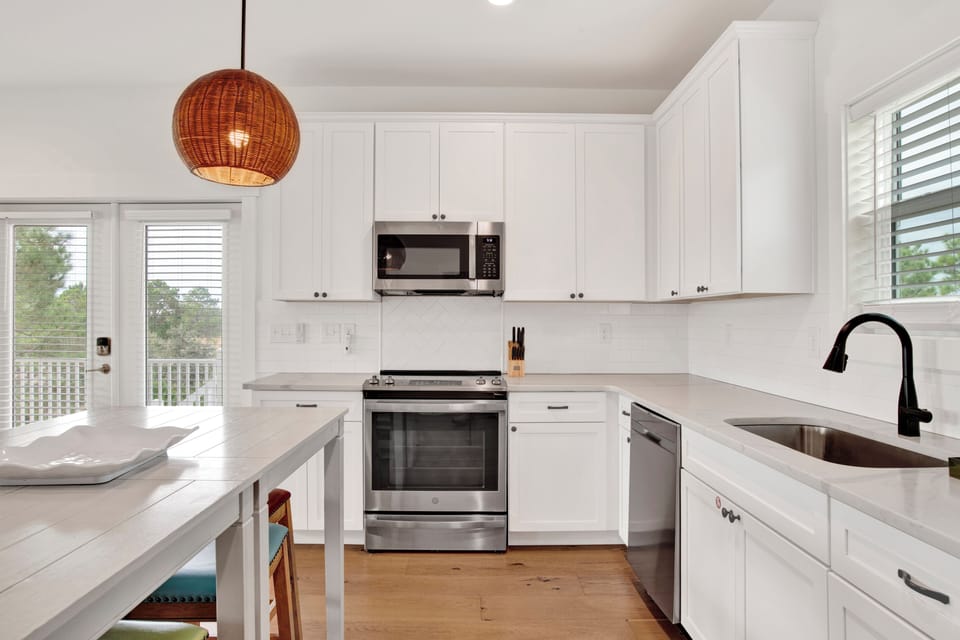 Stone counters and stainless appliances throughout the kitchen