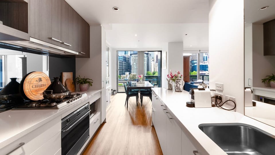 Kitchen with stainless steel appliances and city outlook