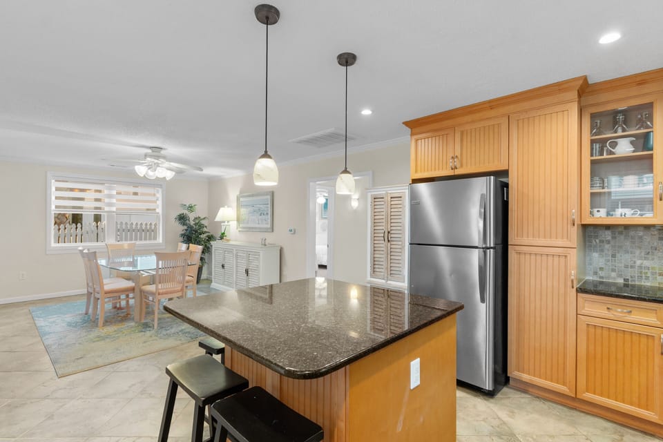 Your gourmet kitchen features granite countertops, stainless steel appliances, and warm wood cabinetry perfect for creating memorable vacation meals together.
