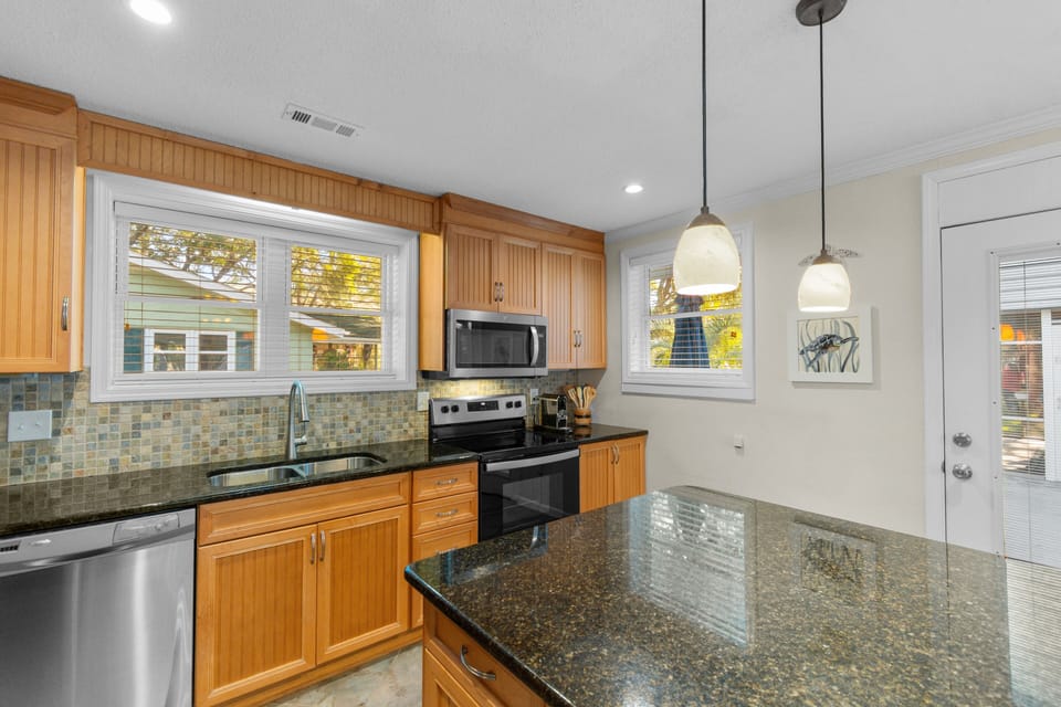 Your gourmet kitchen features granite countertops, stainless steel appliances, and warm wood cabinetry for memorable meal preparation.