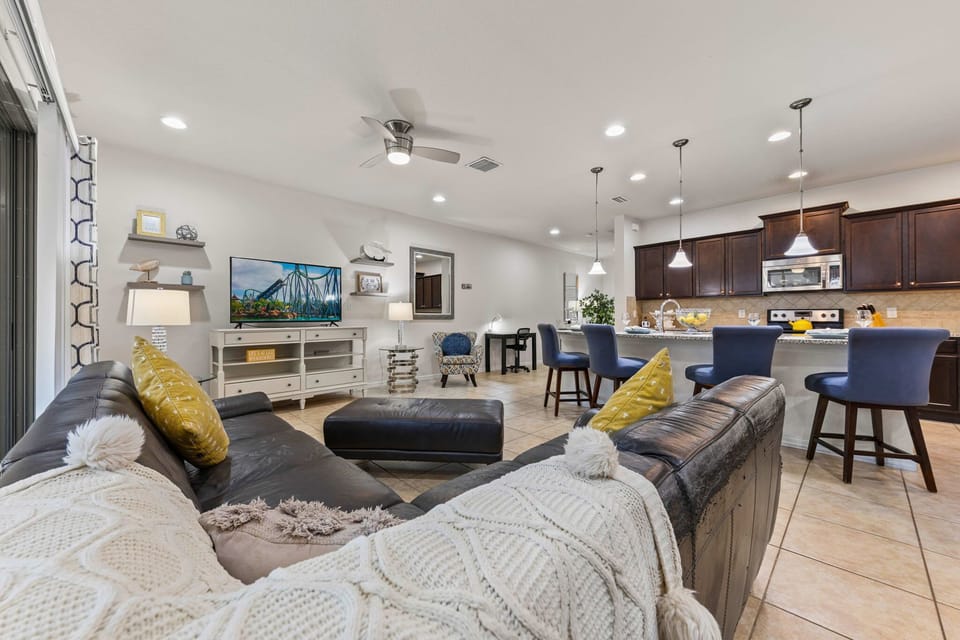 Bright & inviting living space with sleek leather seating, modern décor, and the perfect setup for relaxing after a day of fun!
