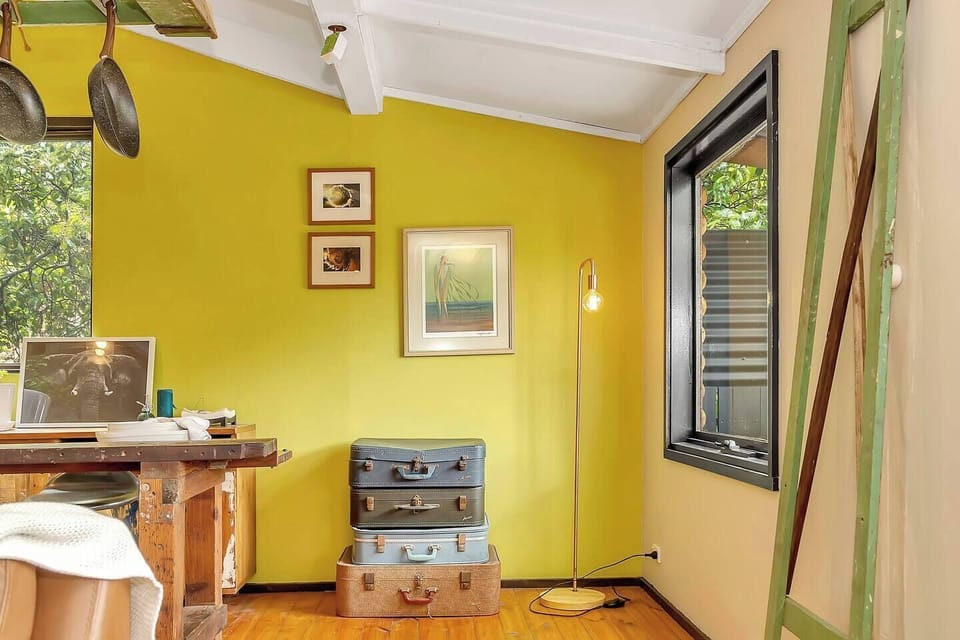 Touches of colour and texture bring a sense of warmth and individuality to the dining space, blending handcrafted artistry with the natural calm of its treetop surroundings.