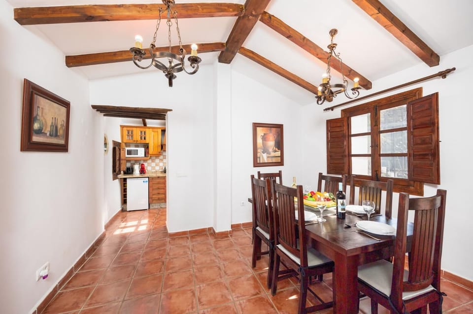 Living room with sofas, dining area, ornamental fireplace, WiFi internet, and satellite TV