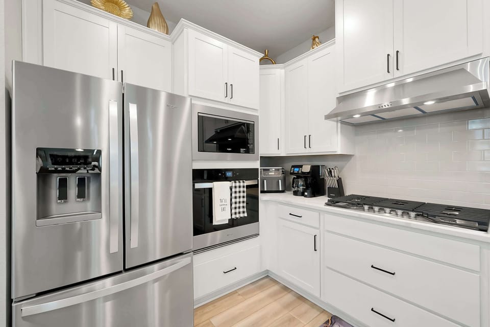 A chef’s paradise — bright, fully equipped kitchen with sleek modern appliances.