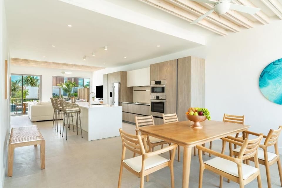 Share long, laughter-filled dinners in a bright coastal dining space.