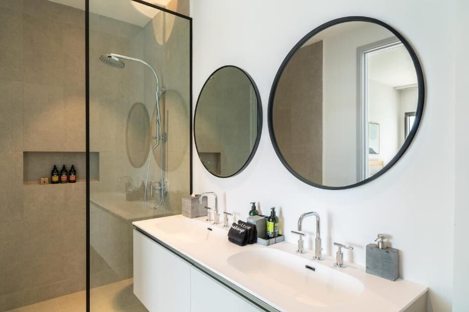 Refresh under a rainfall shower in a spa-clean bath.