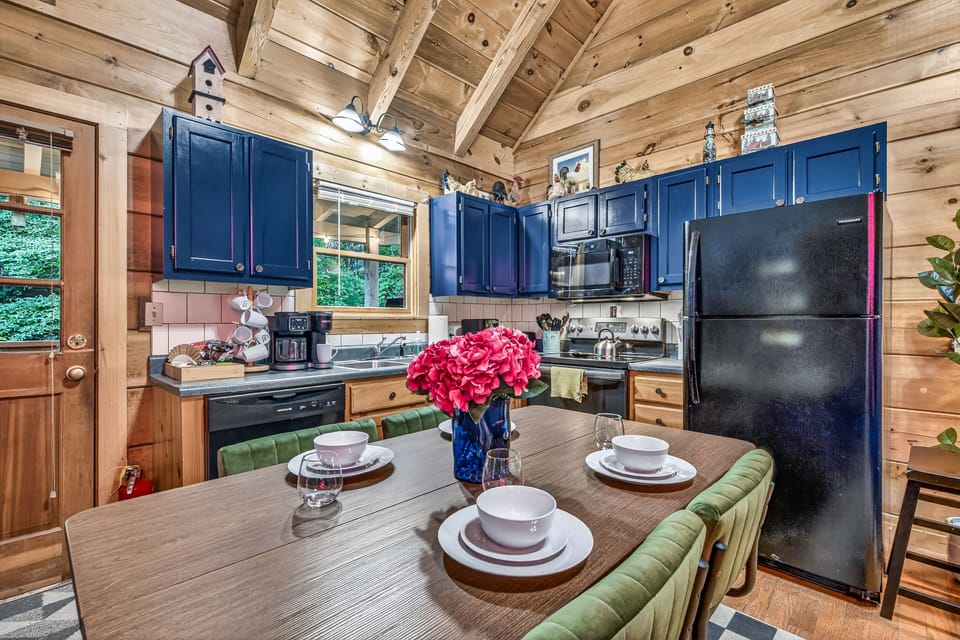 Cozy cabin kitchen with vaulted wood ceilings and dining for four