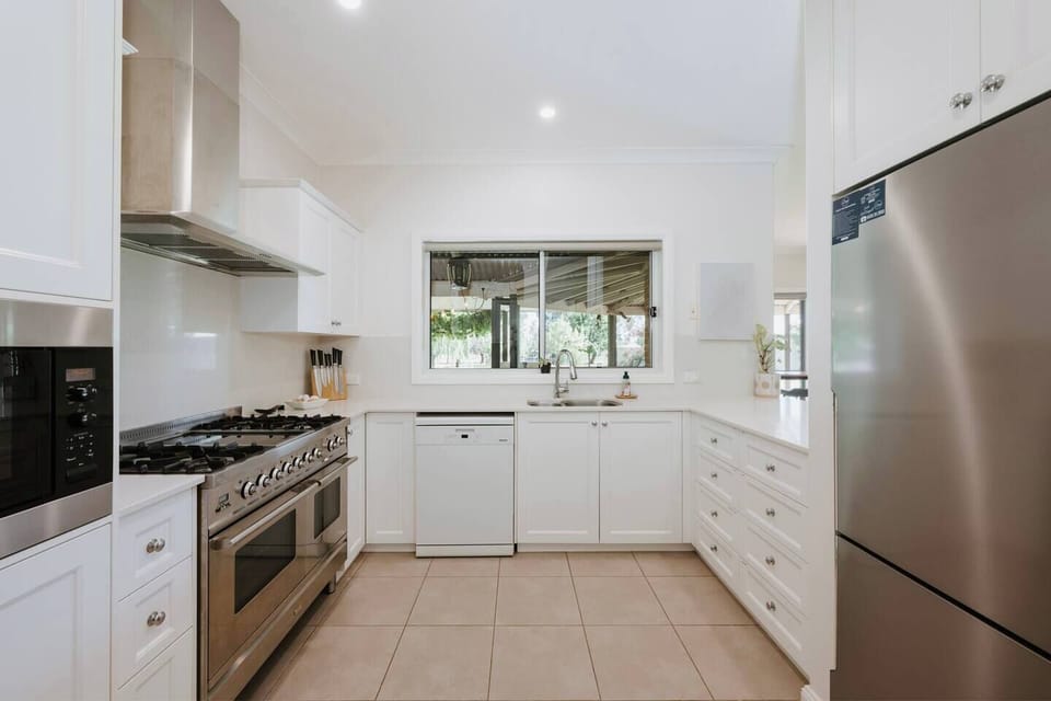 Every culinary need is covered with a gas cooktop, microwave, fridge, dishwasher, espresso machine, and a full pantry stocked with essentials for at-home cooking.