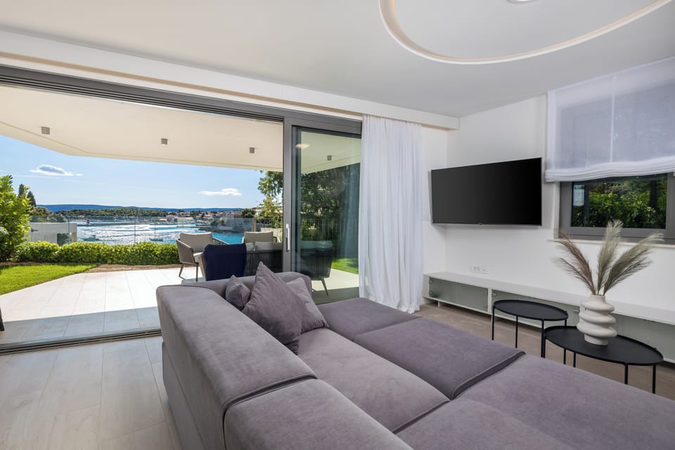 Apartment, Sea View | Living area | Flat-screen TV