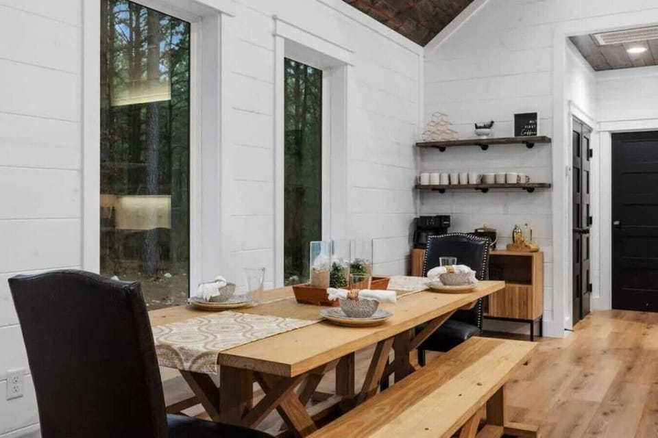 Rustic dining area with wood table, elegant décor, and natural light