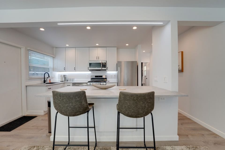 airy open layout with a comfy sectional, bar seating, and a sleek kitchen for easy meals and hangouts.
