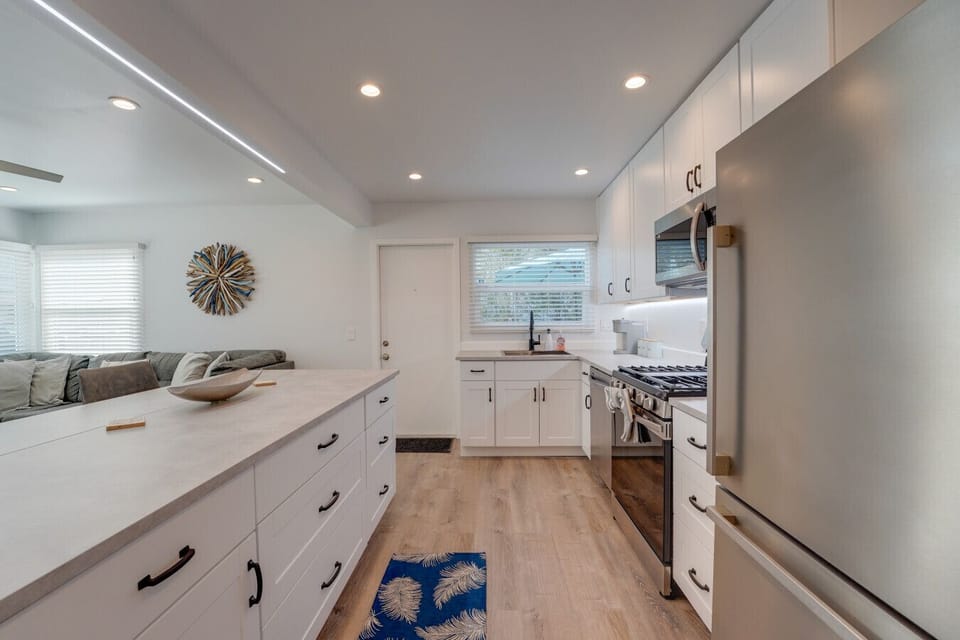 The large kitchen island provides an open space to the living room. Plus, new stainless steel appliances in the kitchen!